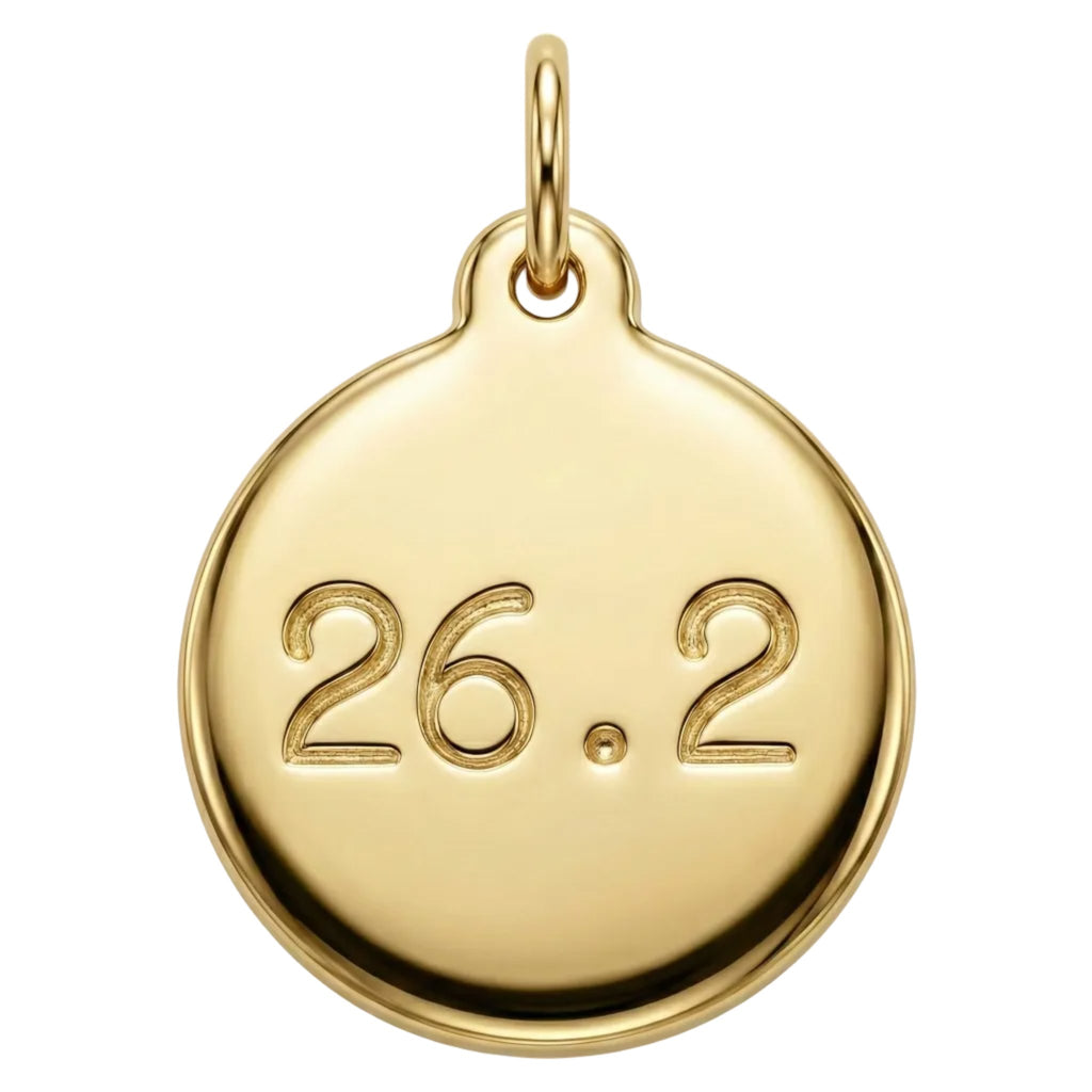 Gold pendant with engraved '26.2' on a white background