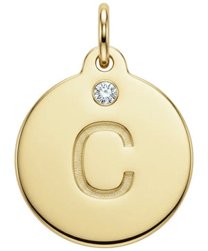 Gold pendant with letter 'C' and small diamond gemstone on a white background
