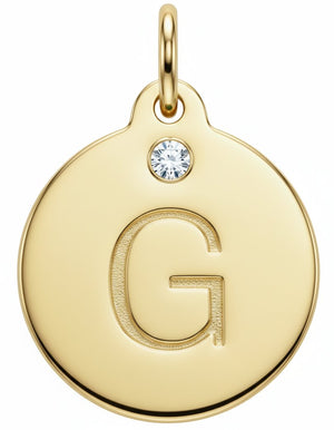 Gold pendant with letter 'G' and diamond gemstone on a white background