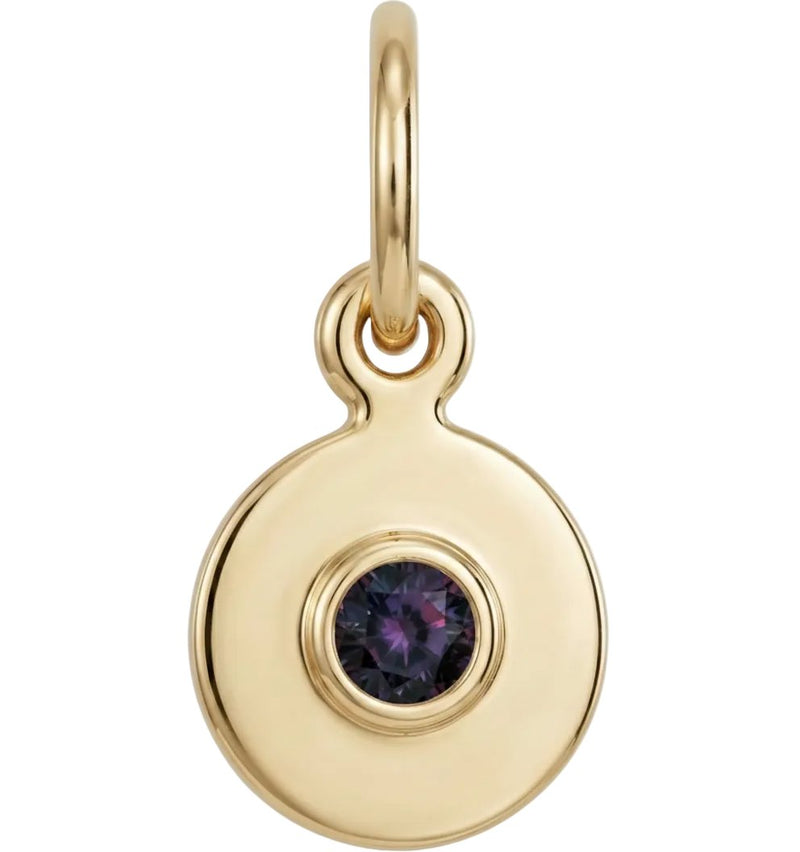 Gold pendant with a purple gemstone on a white background