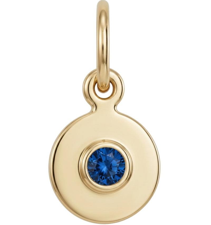 Gold pendant with a blue gemstone on a white background