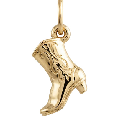Gold cowboy boot charm on a white background