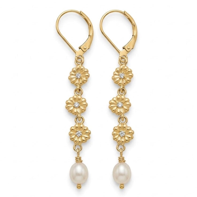 A pair of gold leverback drop earrings with floral motifs, small clear stones, and white pearl beads, shown against a plain white background.