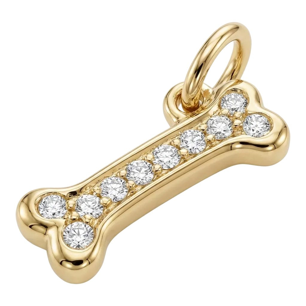 Gold bone-shaped pendant with embedded diamonds on a white background