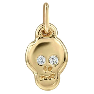 Gold skull pendant with embedded diamonds on a white background