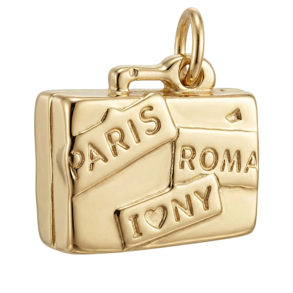 Gold charm shaped like a suitcase with 'Paris', 'Roma', and 'I ❤️ NY' text on a white background