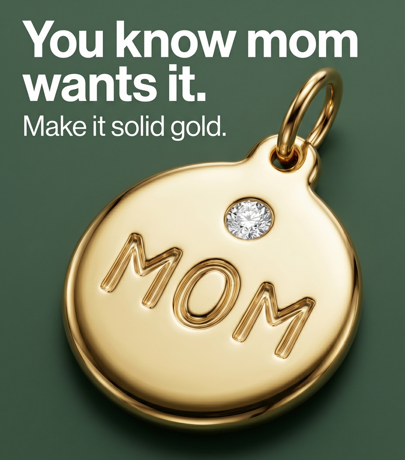 Gold pendant with 'MOM' engraving on a green background