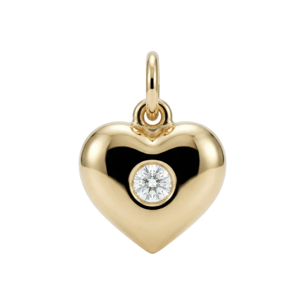 Gold heart-shaped pendant with a diamond on a white background