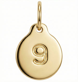 Gold pendant with the number '9' on a white background