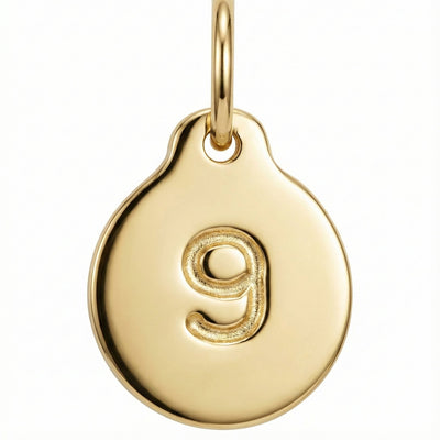 Gold pendant with the number '9' on a white background