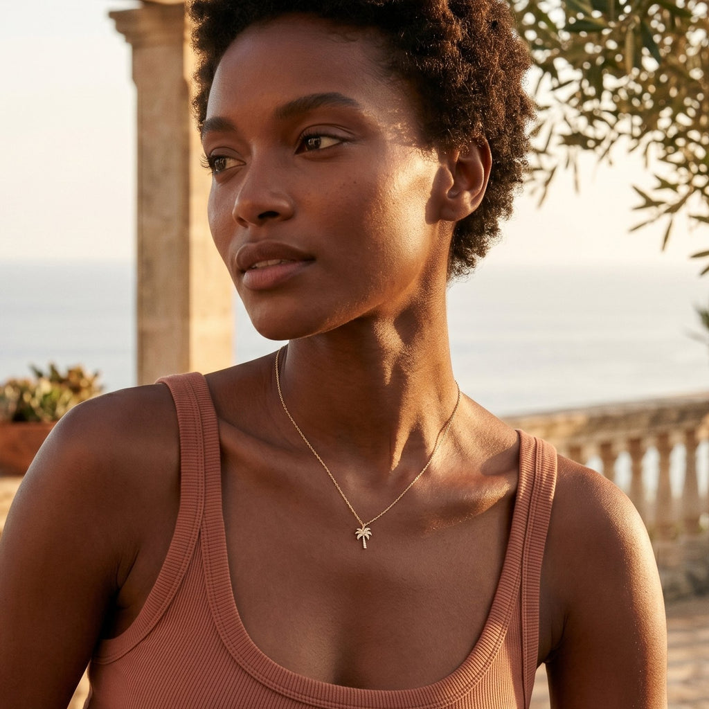 Woman in a brown tank top standing outdoors with ocean view