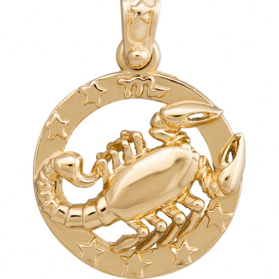 A polished gold pendant featuring a raised scorpion figure set against a circular background with engraved stars and the zodiac symbol, shown on a plain white background.
