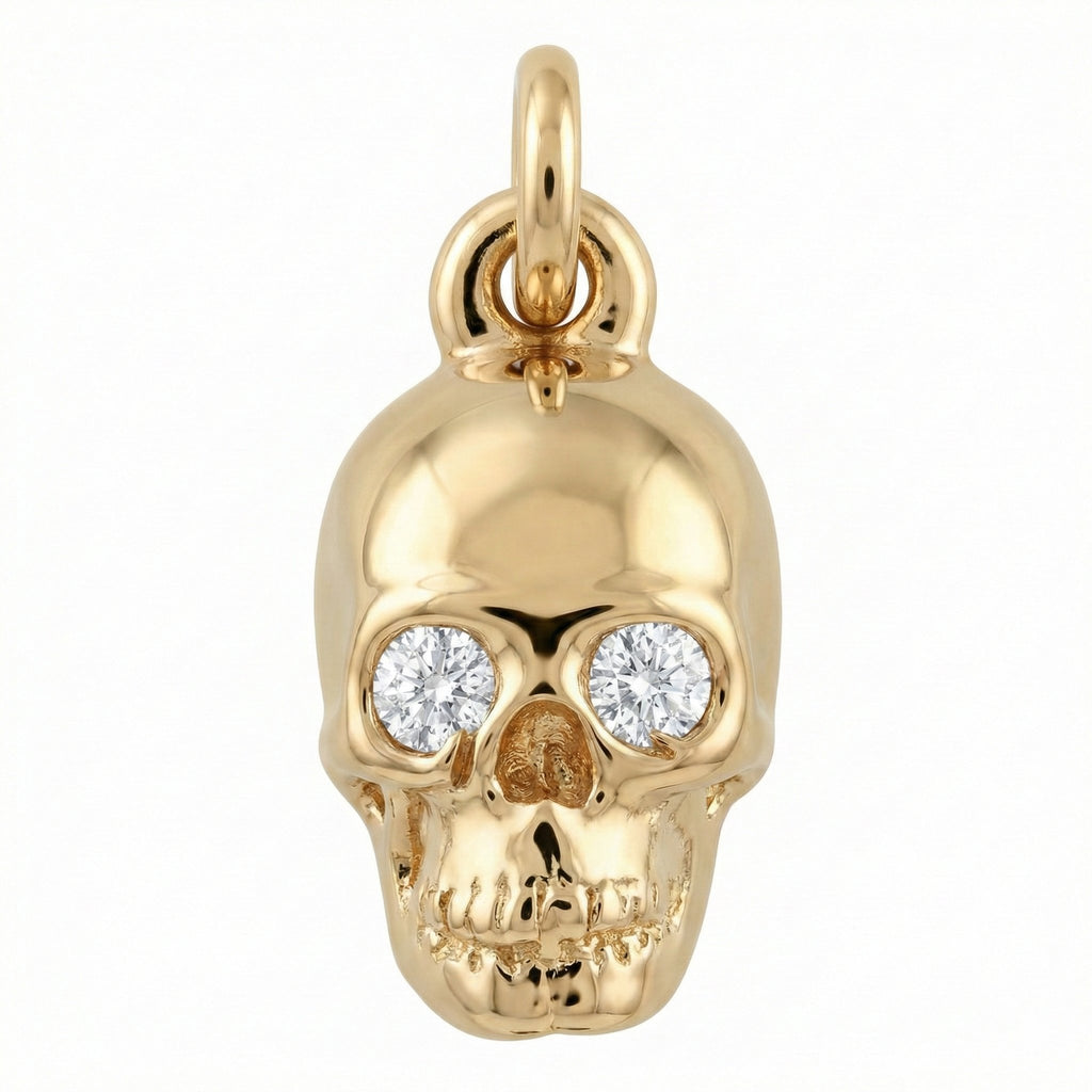 Gold skull pendant with embedded diamonds on a white background