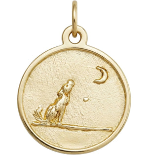 Gold pendant with a dog and moon design on a white background