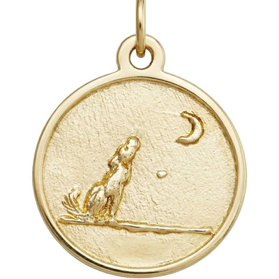 Gold pendant with a dog and moon design on a white background