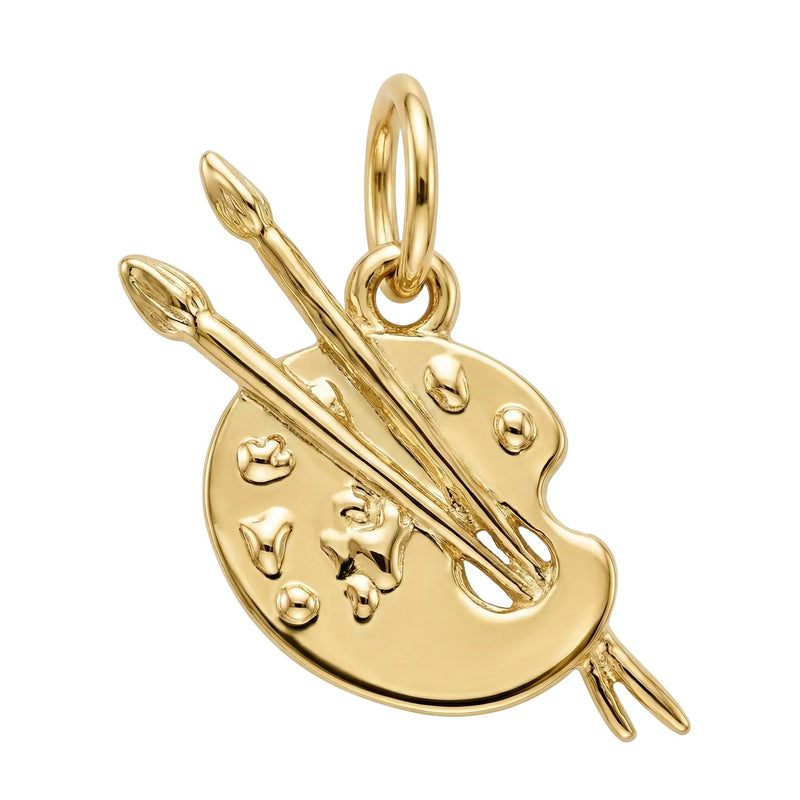Gold pendant shaped like a paint palette with two brushes on a white background