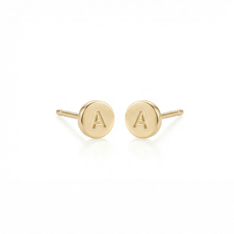 Gold earrings with 'A' initials on a white background